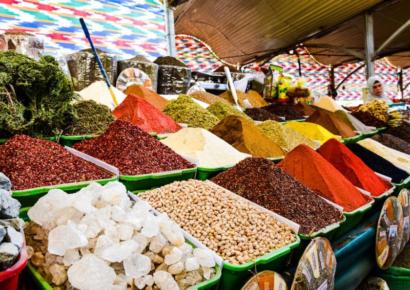 Vibrant display of spices at bazaar market, showcasing variety and color.