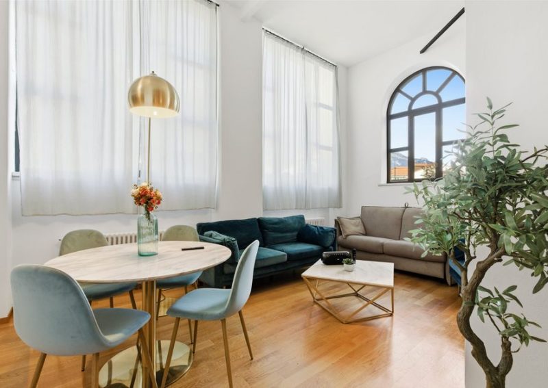 Contemporary living room featuring a cozy seating area with elegant decor and natural lighting.