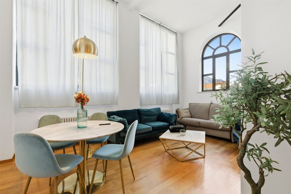 Contemporary living room featuring a cozy seating area with elegant decor and natural lighting.