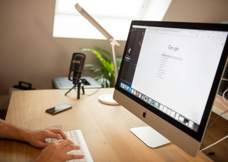 A modern workspace with an iMac displaying Google search, perfect for remote work setups.